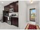 Modern kitchen with stainless steel appliances and dark wood cabinets at 4919 Conifer Cone Dr, Kissimmee, FL 34746