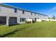 Community backyard with grassy lawn and townhomes at 4919 Conifer Cone Dr, Kissimmee, FL 34746