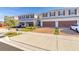 Townhouse exterior with two-car garage and parked cars at 4919 Conifer Cone Dr, Kissimmee, FL 34746