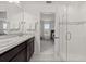 Bathroom with double vanity, shower, and view into bedroom at 4919 Conifer Cone Dr, Kissimmee, FL 34746