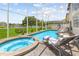 Relaxing pool and spa area with lounge chairs and outdoor seating at 632 Pinewood Dr, Davenport, FL 33896