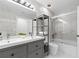 Clean bathroom with double sinks, a shower/tub combo, and marble tile at 632 Pinewood Dr, Davenport, FL 33896