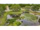 Aerial view of a peaceful community pond with lush landscaping at 632 Pinewood Dr, Davenport, FL 33896