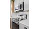 Stainless steel appliances built into gray cabinets at 632 Pinewood Dr, Davenport, FL 33896