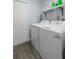 Convenient laundry room with washer, dryer, and overhead shelving at 632 Pinewood Dr, Davenport, FL 33896