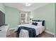 Bedroom with a full bed, light green walls and plenty of light at 632 Pinewood Dr, Davenport, FL 33896