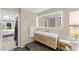 Elegant bathroom with double vanity, large mirror, and a separate shower at 632 Pinewood Dr, Davenport, FL 33896