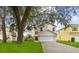 Two-story home with a large garage and landscaping at 632 Pinewood Dr, Davenport, FL 33896