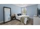 Bedroom with a full bed, large mirror, and plenty of natural light at 632 Pinewood Dr, Davenport, FL 33896