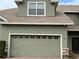 Attached garage with green door and brick pavers at 6364 Sedgeford Dr, Lakeland, FL 33811