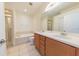 Clean bathroom with double vanity, soaking tub, and shower at 6364 Sedgeford Dr, Lakeland, FL 33811