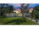 Charming single story home with a gray garage door, well-manicured lawn, and beautiful sunset at 905 Valencia Rd, South Daytona, FL 32119