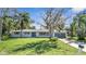 Newly renovated single story home with gray garage door and well-manicured lawn at 905 Valencia Rd, South Daytona, FL 32119