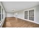 Spacious sunroom with hardwood floors and multiple access points at 905 Valencia Rd, South Daytona, FL 32119