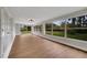 Sunroom with hardwood floors and large windows overlooking the backyard at 905 Valencia Rd, South Daytona, FL 32119