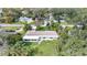 Aerial view of a single Gathering home, neighborhood, and lush trees at 905 Valencia Rd, South Daytona, FL 32119