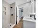 Updated bathroom with double vanity, walk-in shower, and patterned floor tile at 905 Valencia Rd, South Daytona, FL 32119