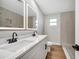 Modern bathroom with double vanity, quartz countertop and updated fixtures at 905 Valencia Rd, South Daytona, FL 32119