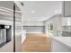 Modern kitchen with white cabinets, stainless steel appliances and hardwood floors at 905 Valencia Rd, South Daytona, FL 32119