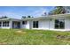 Newly renovated light blue house with sliding glass doors and a grassy backyard at 905 Valencia Rd, South Daytona, FL 32119