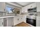 Modern kitchen with white cabinets, stainless steel appliances, and patterned backsplash at 905 Valencia Rd, South Daytona, FL 32119