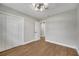 Bedroom with hardwood floors, double door closet and access to hallway at 905 Valencia Rd, South Daytona, FL 32119