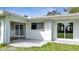 Newly renovated light blue house with sliding glass doors and a spacious backyard at 905 Valencia Rd, South Daytona, FL 32119
