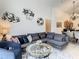 Open concept living room with sectional sofa and view into dining area at 973 Lake Berkley Dr, Kissimmee, FL 34746