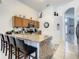 Granite countertop kitchen with stainless steel appliances and breakfast bar at 973 Lake Berkley Dr, Kissimmee, FL 34746
