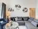 Relaxing living room featuring a sectional sofa and unique wall art at 973 Lake Berkley Dr, Kissimmee, FL 34746