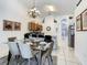 Bright dining room with glass table and chairs near kitchen at 973 Lake Berkley Dr, Kissimmee, FL 34746