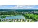 Houses near a lake with mature trees and a park at 973 Lake Berkley Dr, Kissimmee, FL 34746