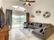 Spacious living area with lake access, sectional sofa and large TV at 973 Lake Berkley Dr, Kissimmee, FL 34746