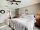 Main bedroom with king bed, ensuite bathroom, and calming decor at 973 Lake Berkley Dr, Kissimmee, FL 34746
