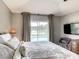 Spacious main bedroom with water views, large bed, and plenty of natural light at 973 Lake Berkley Dr, Kissimmee, FL 34746