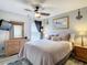 Bedroom with king-size bed, dresser, and views to backyard at 973 Lake Berkley Dr, Kissimmee, FL 34746