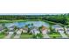Community of homes near a lake with lush greenery at 973 Lake Berkley Dr, Kissimmee, FL 34746