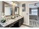 Double vanity bathroom with granite countertops and modern fixtures at 973 Lake Berkley Dr, Kissimmee, FL 34746