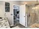Bathroom with walk-in shower, granite vanity and access to bedroom at 973 Lake Berkley Dr, Kissimmee, FL 34746