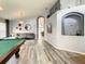 Open game room with pool table and access to other rooms at 973 Lake Berkley Dr, Kissimmee, FL 34746