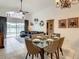 Dining area with glass table and chairs, view into living and kitchen areas at 973 Lake Berkley Dr, Kissimmee, FL 34746