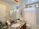 Bathroom with granite countertop, shower/tub combo, and updated vanity at 973 Lake Berkley Dr, Kissimmee, FL 34746