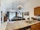 Open concept kitchen with granite island and stainless steel appliances at 973 Lake Berkley Dr, Kissimmee, FL 34746
