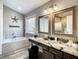 Spa-like bathroom with soaking tub, double vanity, and walk-in shower at 973 Lake Berkley Dr, Kissimmee, FL 34746