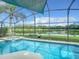 Refreshing screened pool and spa with lake views at 973 Lake Berkley Dr, Kissimmee, FL 34746