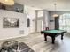 Game room with pool table, comfortable seating, and high ceilings at 973 Lake Berkley Dr, Kissimmee, FL 34746