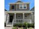 Two-story home with gray siding, white trim, and a front porch at 1608 Cross Prairie Pkwy, Kissimmee, FL 34744