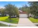 Single-story home with a red tile roof and attached garage at 9016 Murano Mews Ct, Kissimmee, FL 34747