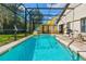 Relaxing screened-in pool area with patio furniture at 9016 Murano Mews Ct, Kissimmee, FL 34747