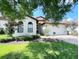 One-story home with white stucco and a terracotta tile roof at 9016 Murano Mews Ct, Kissimmee, FL 34747